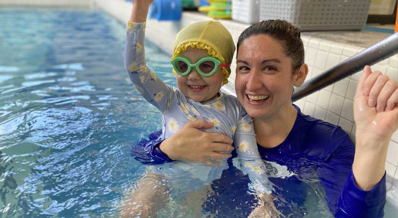 A Njswim Schools swimming teacher with a young girl in the pool