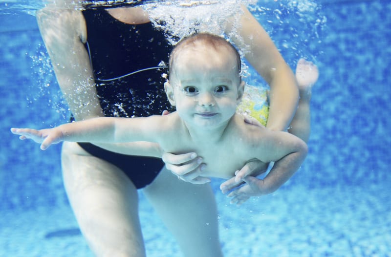 Baby Swimming Underwater with Mom's Support