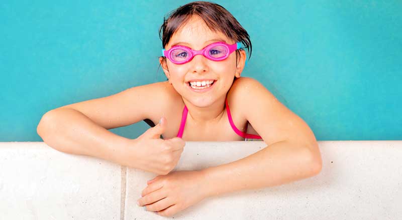 A confident and smiling Njswim student in the pool